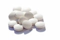 Many generic small round white pills, lots of little tablets on white background closeup. Simple group of little pills, medicine