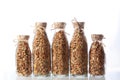 Many glass bottles with granola or muesli on a white background. An isolated object. Copy of the space. Horizontal photo Royalty Free Stock Photo