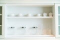 Many glass bottles set in white wooden cabinet Royalty Free Stock Photo