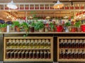 Many glass jars with jam and lemonade inside bright cafe with colorful interior