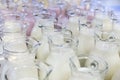 Many glass jugs with milk and yogurt
