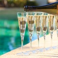 Many glasses of champagne or prosecco near resort pool in a luxury hotel. Pool party. Royalty Free Stock Photo