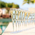 Many glasses of champagne or prosecco near resort pool in a luxury hotel. Pool party. Royalty Free Stock Photo