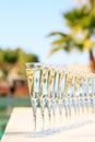 Many glasses of champagne or prosecco near resort pool in a luxury hotel. Pool party.