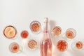Many glasses of rose wine and bottle sparkling pink wine top view. Light alcohol drink for party.