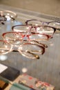 Many glasses rows at optical retail store. Rich assortment choice of different eyewear frames on eyeglasses shop display Royalty Free Stock Photo