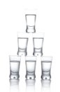 Many glasses of vodka isolated on white background