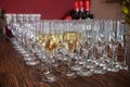 Many glasses with white wine on buffet table. Soft focus, selective focus