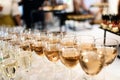 Many glasses of white wine stand in a row on the table Royalty Free Stock Photo