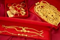 The Many gold necklaces and gold bars in red box on red velvet cloth background Royalty Free Stock Photo