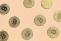 Many golden bitcoins lies on a blanket made of soft and fluffy light orange fleece fabric. Physical visualization of virtual