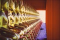 Many golden buddha statues sit in row at the temple and are clearly in the middle of the image. Royalty Free Stock Photo