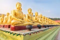 Many golden buddha statues sitting in row at public temple nakornnayok thailand Royalty Free Stock Photo