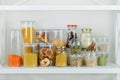 Many of grain products and pasta in glass storage containers on white wooden table. Healthy vegan cooking, clean eating, zero