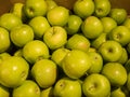 Many green delicious apples in a box in the store Royalty Free Stock Photo