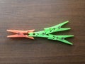 Many green and orange color plastic Clothespins Royalty Free Stock Photo