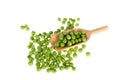 Many green peas with wooden spoon