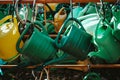 Many green and yellow watering cans