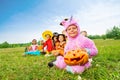 Many Halloween kids wear costumes sit in long row Royalty Free Stock Photo