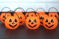 Many halloween pumpkins with scary faces looking forward