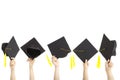 Many hand holding graduation hats Royalty Free Stock Photo