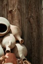 Many handmade old clay pots on the wooden background. Royalty Free Stock Photo