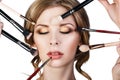 Many hands applying make-up to glamour woman. Royalty Free Stock Photo