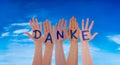 Many Hands Building Danke Means Thank You, Blue Cloudy Sky Royalty Free Stock Photo