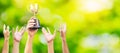 Many hands raised up. Winner is holding trophy cup in hand. on blurred green background Royalty Free Stock Photo