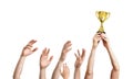 Many hands raised up. Winner is holding trophy in hands. Isolated on white background Royalty Free Stock Photo