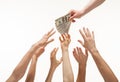 Many hands reaching out for money Royalty Free Stock Photo