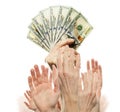 Many hands want money. 100 American dollars cash money in one hand  and many empty hands isolated on white background Royalty Free Stock Photo