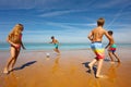 Many happy children play soccer ball on sea beach Royalty Free Stock Photo