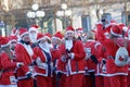 Many happy Santas in traditional red dresses and beard in the St