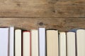 Many hardcover books on wooden table, space for text