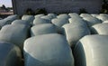 hay bales coating with plastic film for protection in case of ba Royalty Free Stock Photo