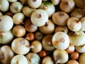 Many heads of Golden and brown onions are lying on the table, close-up, top view. Organic, agricultural culinary background. Royalty Free Stock Photo