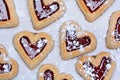 Many heart cookies on baking paper