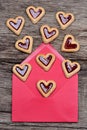 Many heart cookies in an envelope on table