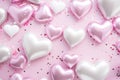 many heart heart foil balloons surrounding pink confetti