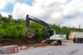 Many heavy heavy industrial road construction machinery on new highway road construction site sunny day with blue sky Royalty Free Stock Photo