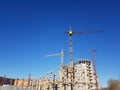 Many high-rise buildings and cranes under construction under the blue sky Royalty Free Stock Photo