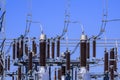 Many high voltage electrical insulators in power substation against blue sky Royalty Free Stock Photo