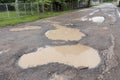 many hole and flooding on asphalt road