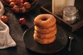 Many homemade baked donuts without cream lies on old rustic wooden table