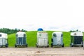 Many horse trailers in the green park outdoors. Royalty Free Stock Photo