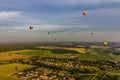 Many hot air balloons over a field, forest, village Royalty Free Stock Photo