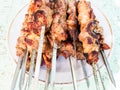 many hot cooked skewered shish kebabs on plate