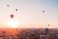 Many huge balloons are flying in the air at the sunrise. Cappadocia, Turkey.