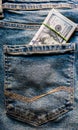 Many hundred dollar bills in jeans pocket. US dollars are visible in your pocket. 100 dollar bills sticking out of a denim pocket Royalty Free Stock Photo